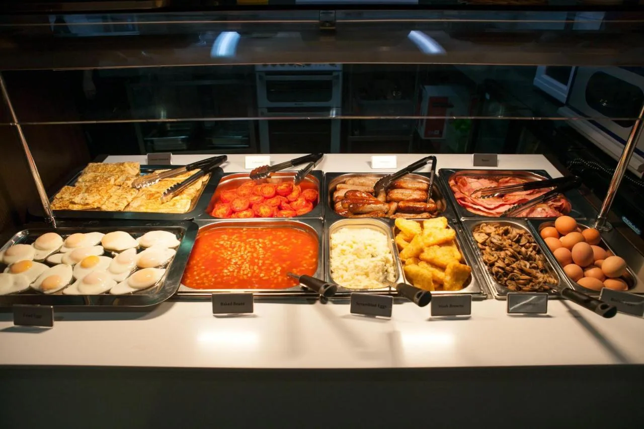 a buffet with many different types of food in trays at Best Western Victoria Palace in London